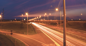 Illuminated streetlights along highway at night
