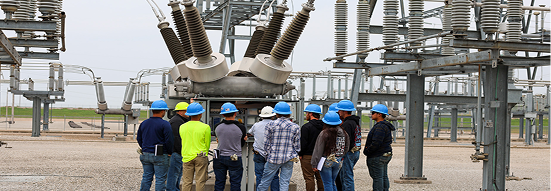 BPU workers in hard hats inspecting electrical substation equipment