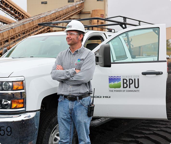 BPU employee with company truck at facility