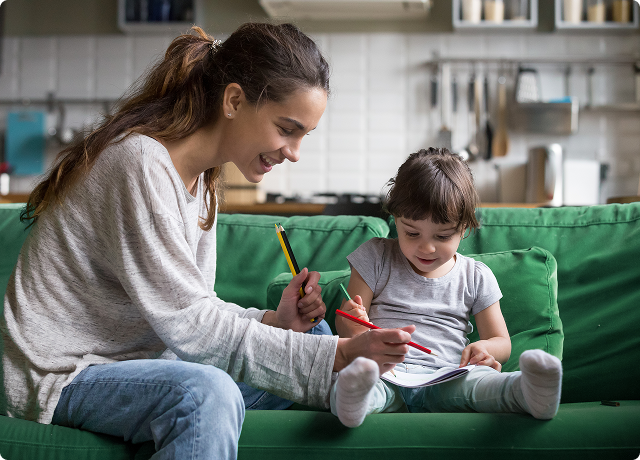 Mother and child playing together on couch