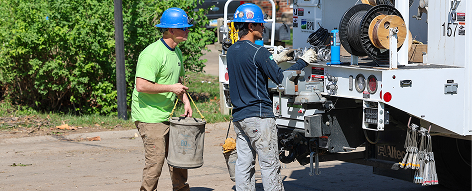 BPU crew working near truck on residential street